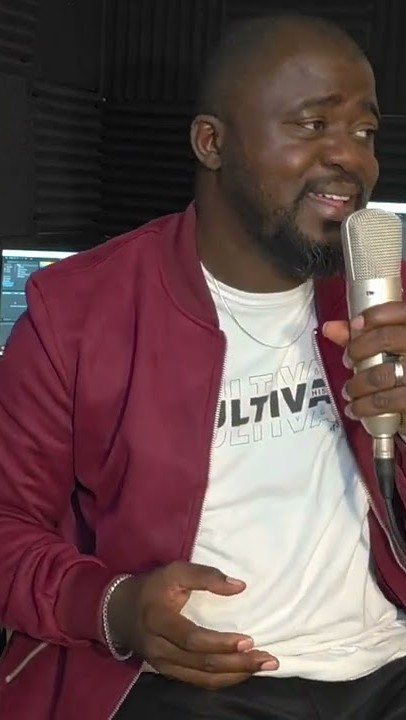 Soji singing into a studio microphone